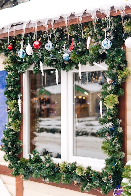 Christmas window decor. Street, winter, icicles. Christmas tree decoration on the street