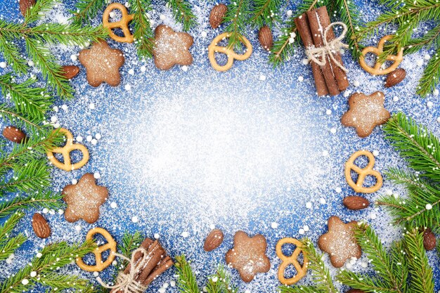 Christmas winter background Spicy ginger cookies pretzels flour Copy space Slate and snow