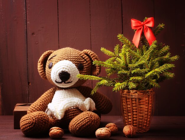 Christmas winter bear with fir tree and glowing garland