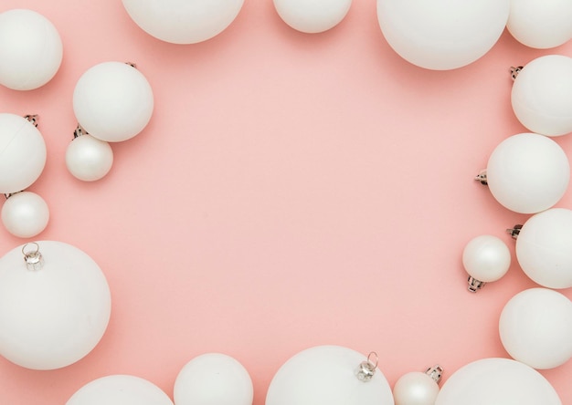 Christmas winter composition White christmas balls on a pastel pink background