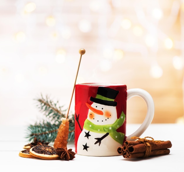 Christmas winter hot drink in a cup with spices. winter holiday still life. festive new year background with bokeh.