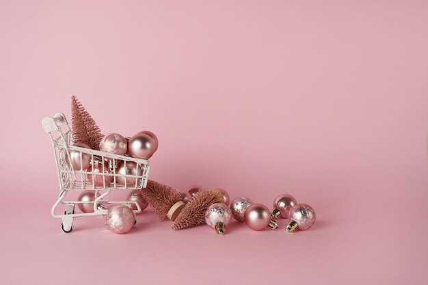 Christmas winter shopping cart with decor on pink