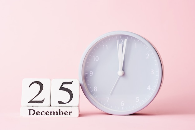 Christmas  with alarm clock on pink 