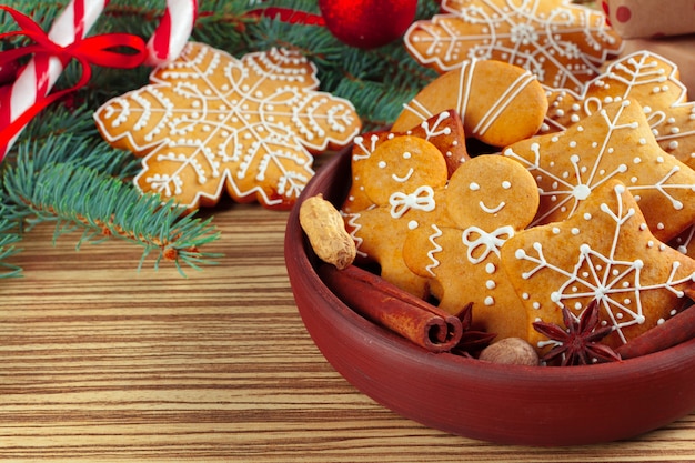 Christmas with branch of fir tree decorated by gingerbread.