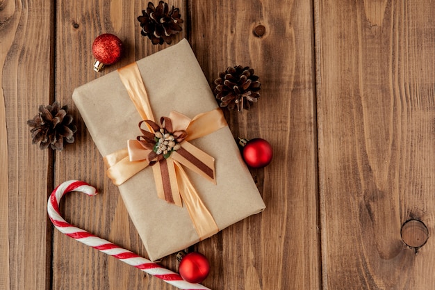 Christmas  with Christmas cones and toys, fir branches, giftboxes and decorations on a wooden table 