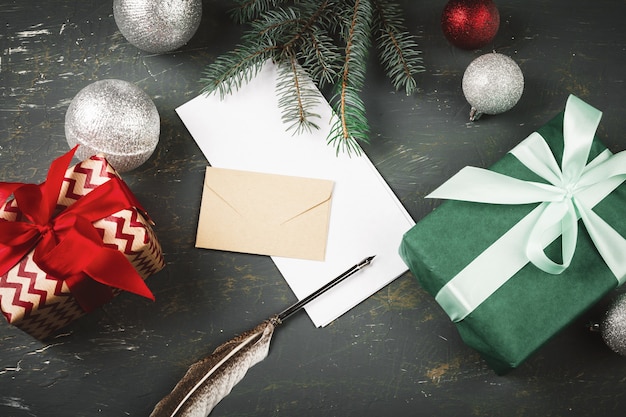 Christmas   with letter, envelope and feather  pen surrounded by seasonal decorations