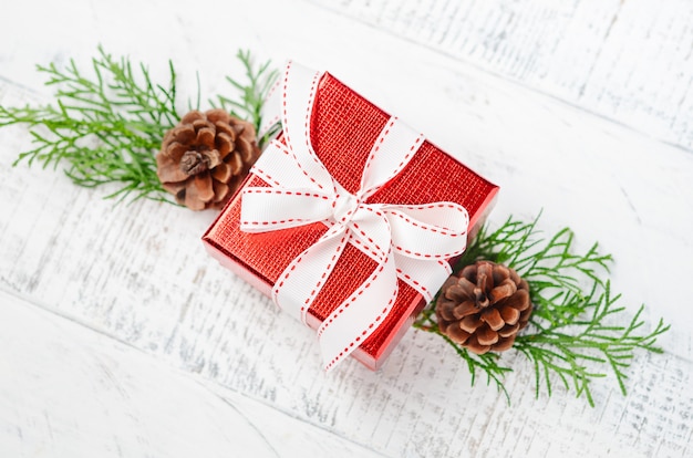 Christmas  with red gift box on a white wooden background. Winter festive . Top view, flat lay, copyspace.