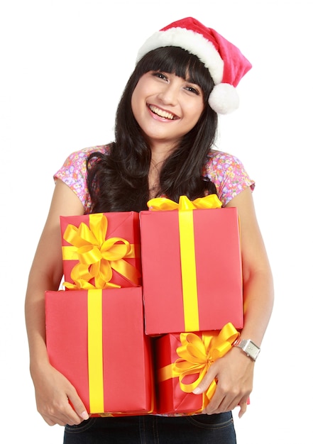 Christmas woman holding gifts wearing Santa hat