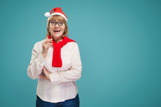 Christmas woman in shirt and jeans on blue background