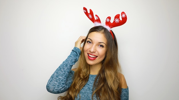 Christmas woman with reindeer horns smiling happy