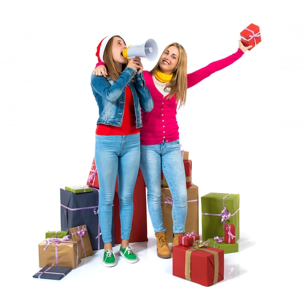 Christmas women holding gifts over white background