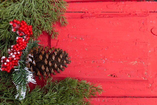 Christmas wood red background with christmas decorations top view Copy space