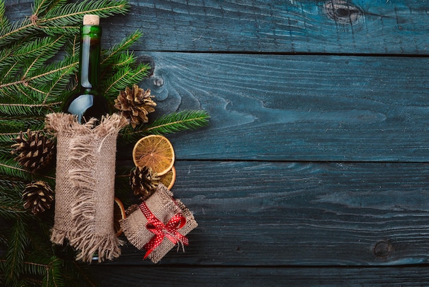 Christmas wooden background A bottle of wine New Years holiday Christmas motive On a wooden surface Top view Free space for your text