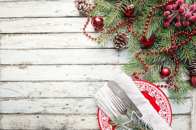 Christmas wooden background with fir tree and decorations. Top view with copy space