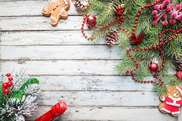 Christmas wooden background with fir tree and decorations. Top view with copy space