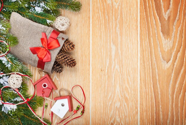 Christmas wooden background with snow fir tree and decor