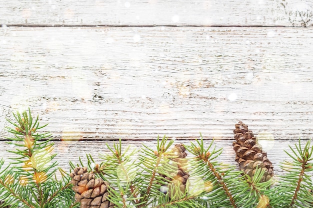 Christmas wooden background with snow fir tree. top view with
copy space for your text