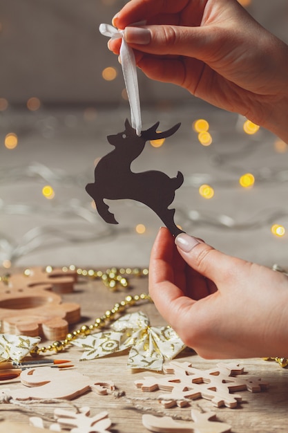 Christmas wooden decoration, Christmas deer in woman hands