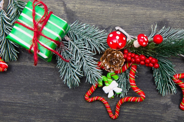 Christmas wooden surface with Christmas tree and red decorations. Christmas Wreath with Rustic Wood surface.