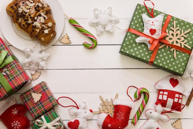 Christmas wooden table with gifts in the borders. Copy space for text. Flat lay for winter holidays