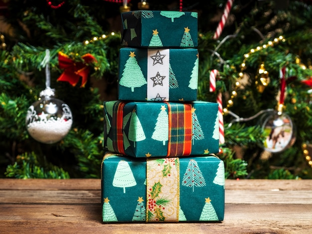 Christmas wrapped gift boxes on the wooden table.