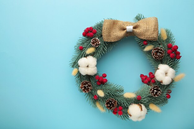 Christmas wreath on a blue background with copy space.