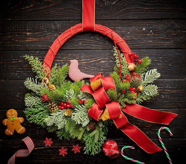 Christmas wreath on dark wooden background