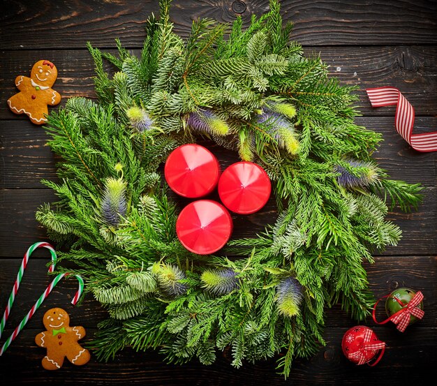 Christmas wreath on dark wooden background