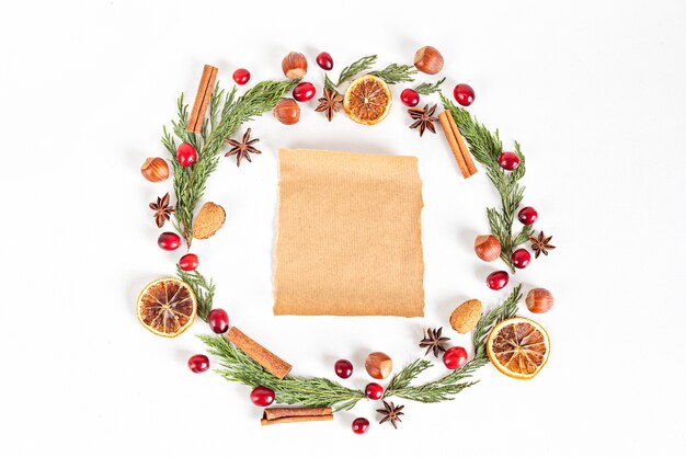 Christmas wreath frame with nuts and cranberries, flat lay, top view.