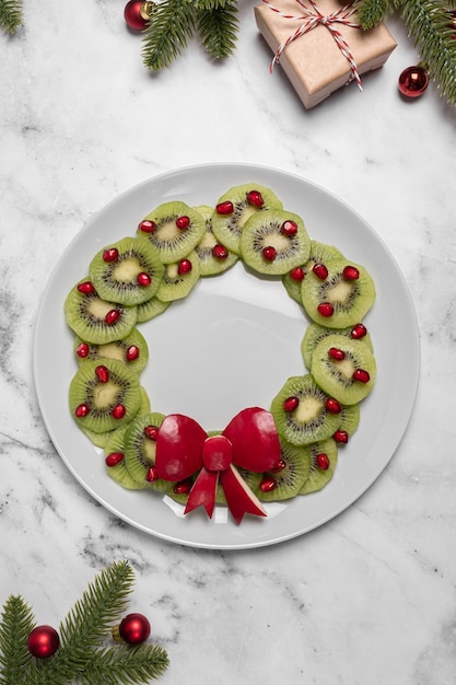 Christmas wreath fruit salad with kiwi and pomegranate