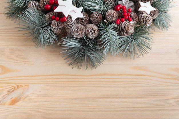 Christmas wreath on light wooden background Winter Holiday pattern Copy space