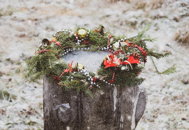 Christmas wreath on a tree stump