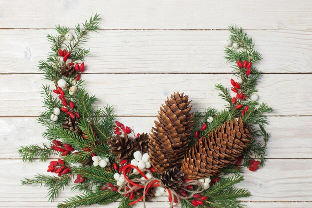 Christmas wreath on white wooden backdrop