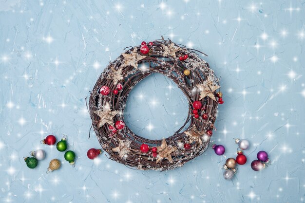 Christmas wreath with decoration on blue background.