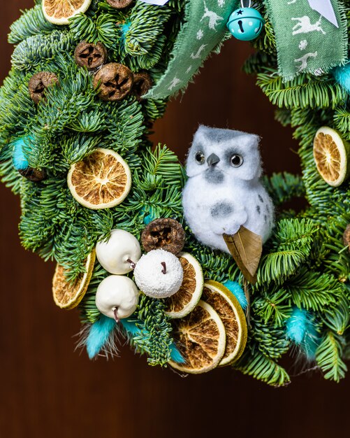 Christmas wreath with fruits and an owl