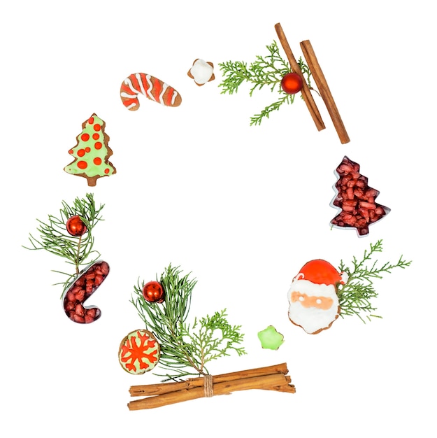 Christmas wreath with gingerbread cookies and decorations isolated on white background