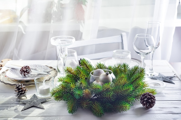 Christmas wreath with toys on the table with Silver Christmas Table Setting 