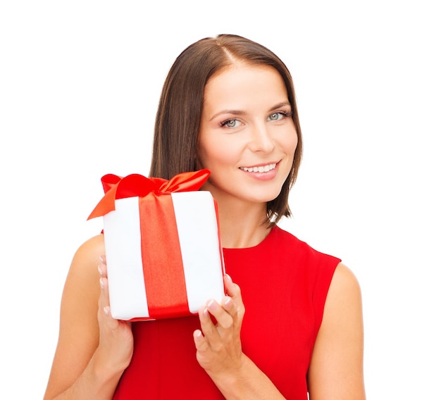 christmas, x-mas, valentine's day, celebration concept - smiling woman in red dress with gift box