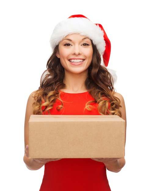 christmas, x-mas, winter, happiness concept - smiling woman in santa helper hat with parcel box