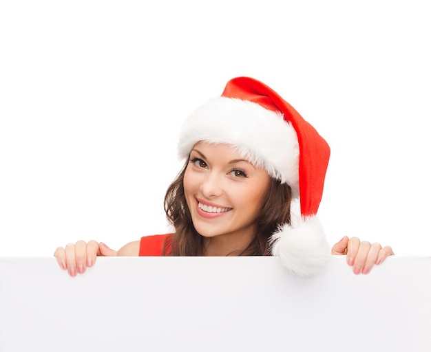 christmas, xmas, holidays and advertisement concept - happy asian woman in santa helper hat with blank white board