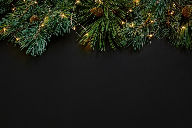 Christmas. Xmas toys and spruce branch on black background top view. Copy space. Still life. Flat lay. New year