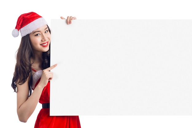 Christmas young asian woman showing blank billboard banner sign smiling happy