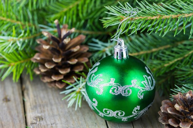 Christmass ball with fur-tree branches and cones