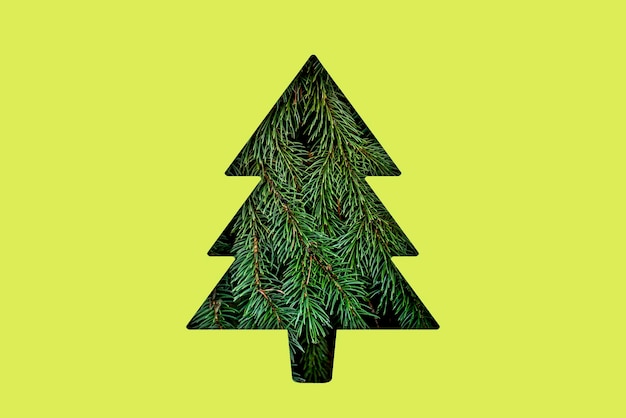 A christmass tree shape cut in the colorful surface creative holidays concept