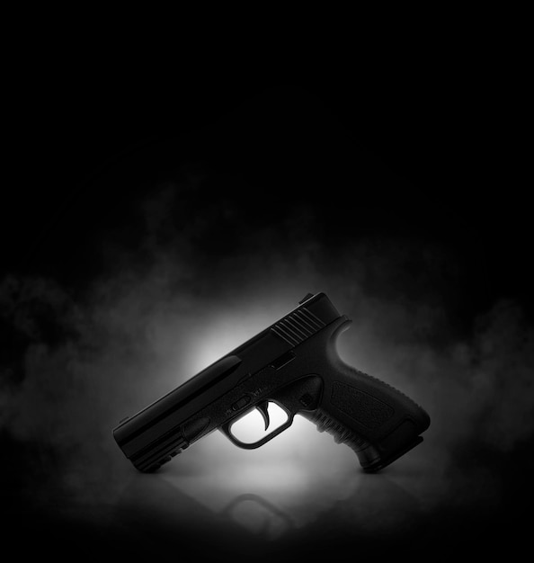 Chrome gun on black background with smoke