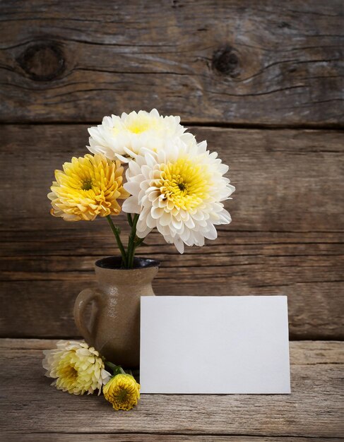 Chrysanthemum flower with blank card on aged wooden background