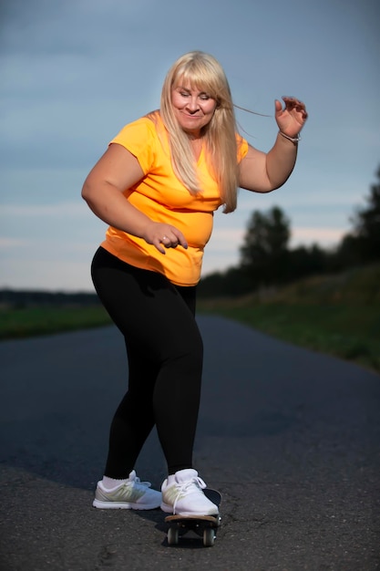 Chubby middleaged European woman overweight in a tracksuit learns to ride