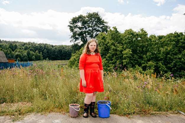 Chubby young girl posing in the countryside