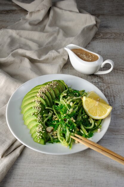 Chukka salad, cucumber noodles with avocado and peanut brown sauce in sauceboat