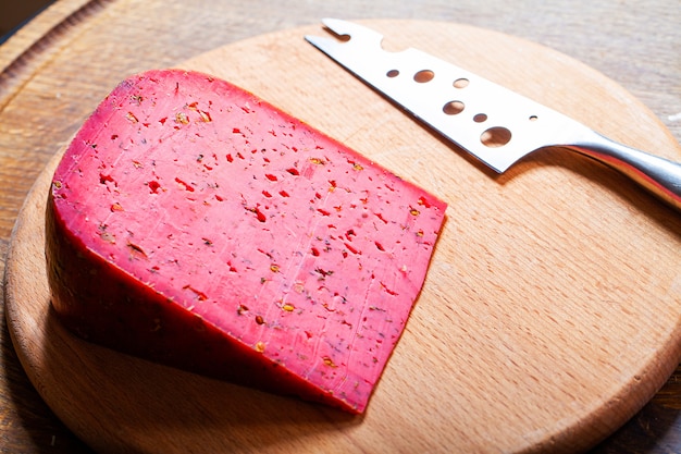 Chunk of red cheese on wooden